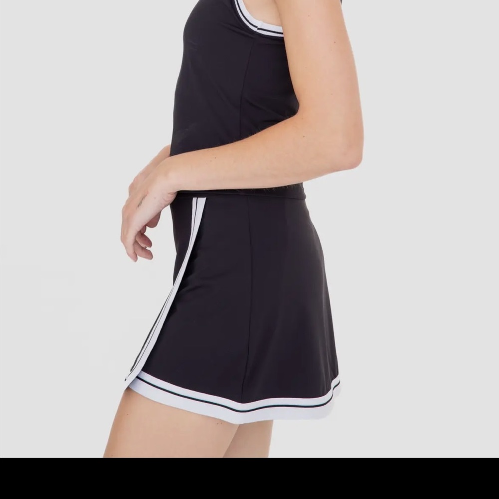 Tennis, pickleball skirt. Apron style w built in shorts. Black w white piping.
